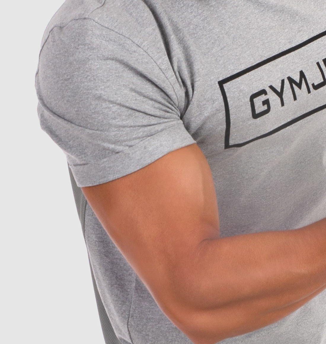 GymJet gray t-shirt worn by a person flexing their arms, showcasing fit and comfortable gym wear