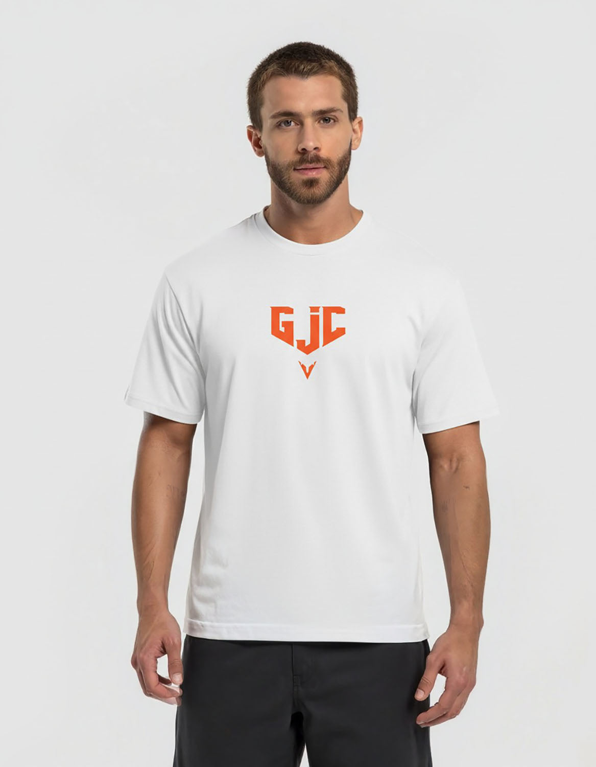 Man wearing a white t-shirt with an orange logo on a light gray background