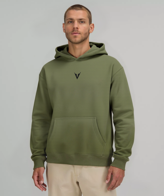 Man wearing a green hoodie with a logo on a gray background