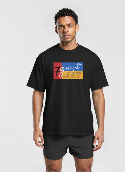Man wearing a black t-shirt with colorful graphic design on a white background