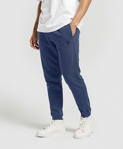 Man wearing a white t-shirt and blue pants on a white background