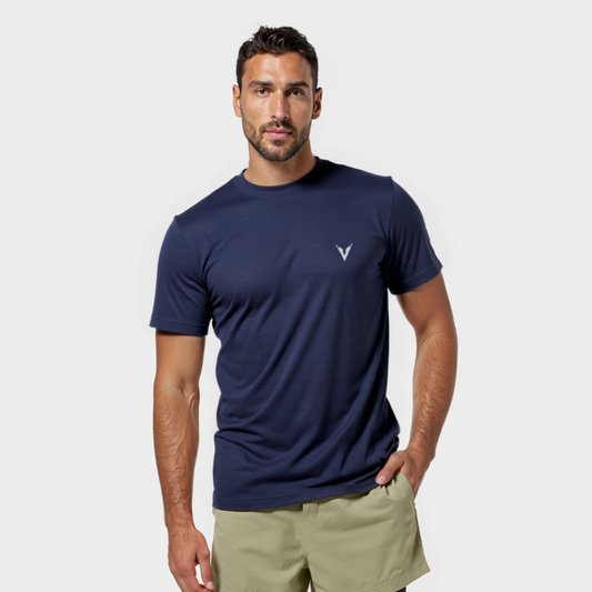 Man wearing a navy t-shirt and beige shorts on a white background